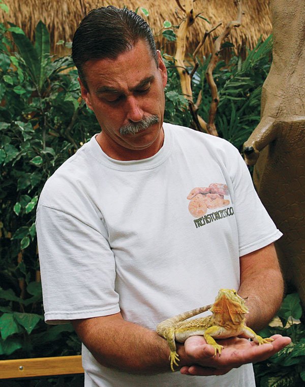 holding a bearded dragon