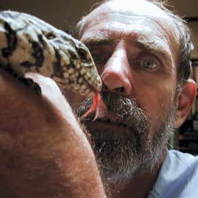 Mr. Langerwerf holding the topic of his last article, a black and white Argentine tegu