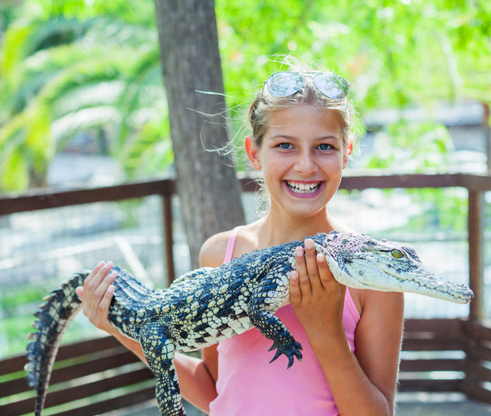 girl holding crocodilian