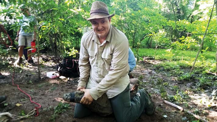 Mike Wines holds onto a Komodo dragon