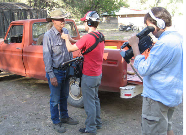 The crew conducting a mic check on location